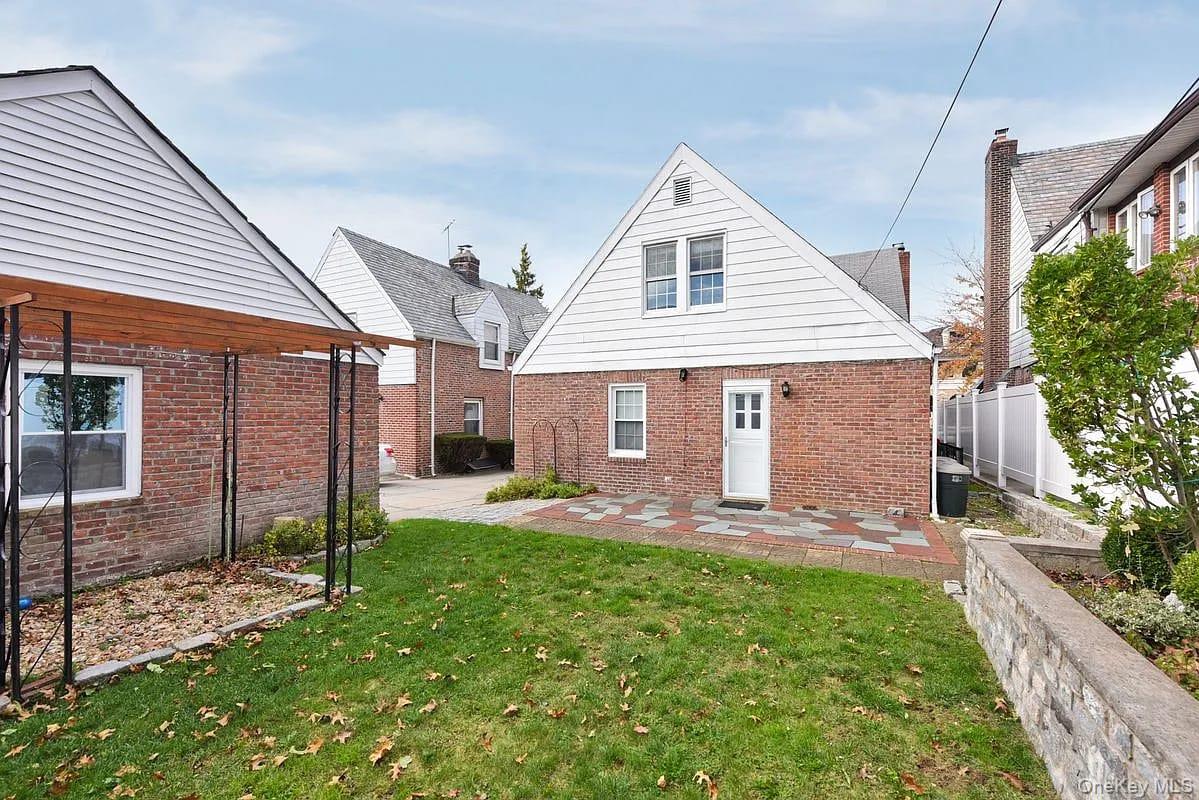 108-30 67th Avenue Queens, NY 11375 - Photo 27 of 29 a front view of a house with a yard and porch