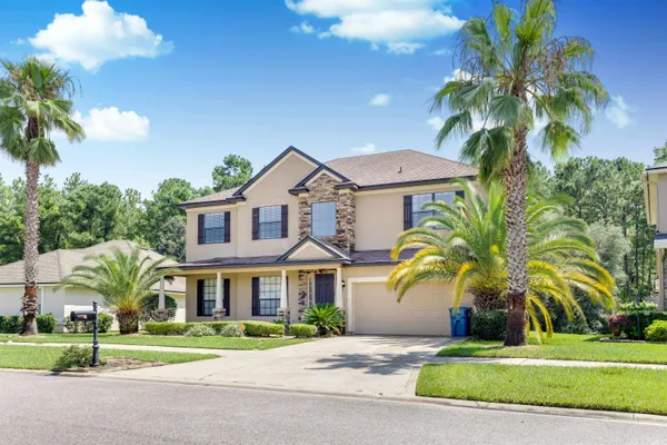 a front view of house with yard and green space