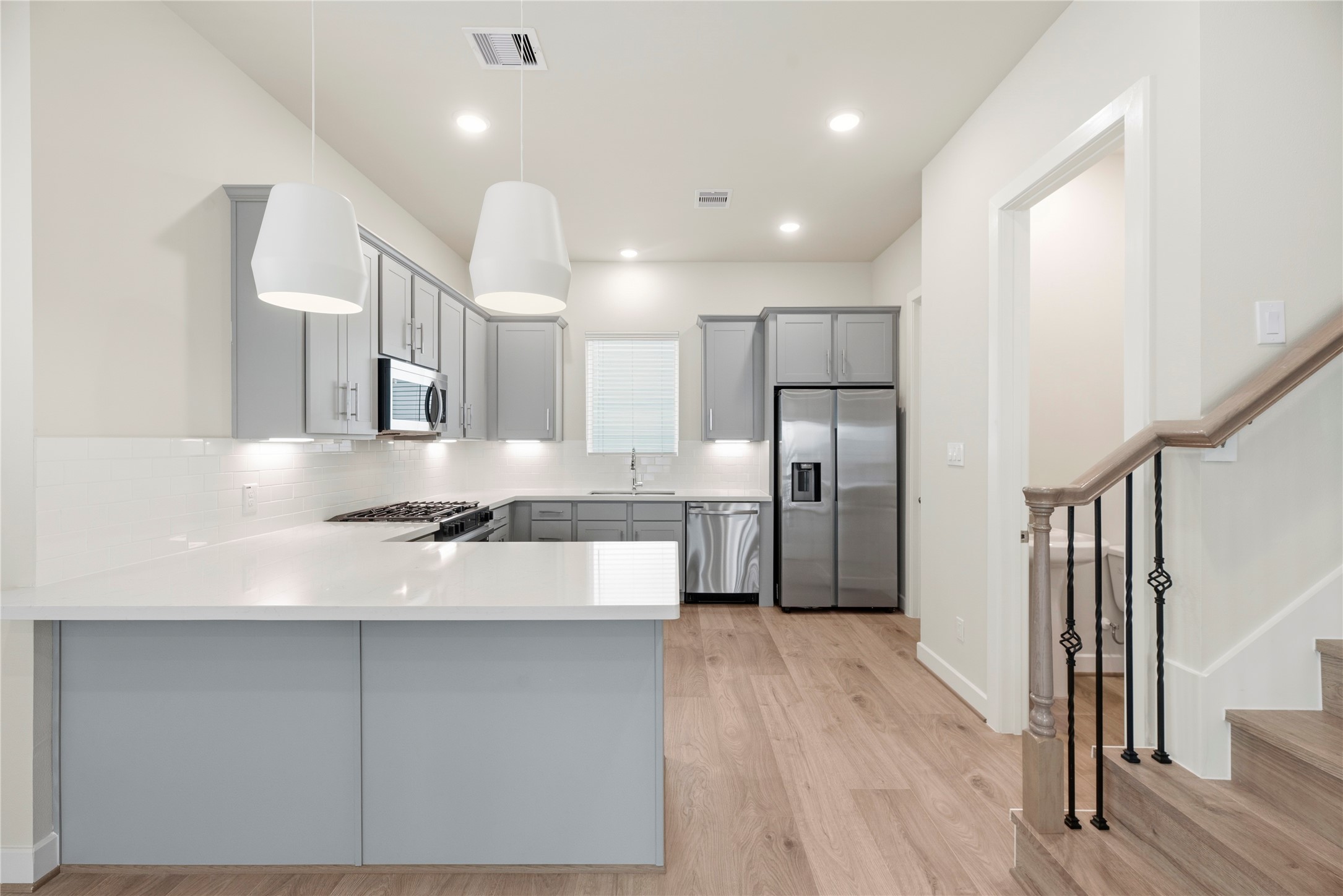 3075 Hicks Street Houston, TX 77007 - Photo 11 of 34 a kitchen with stainless steel appliances granite countertop a refrigerator a sink dishwasher a stove and a refrigerator with wooden floor