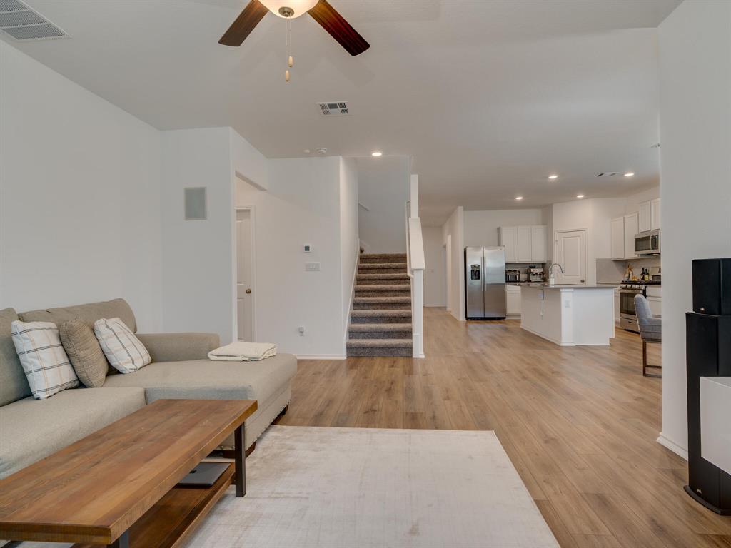 1208 Sweetspire Street Leander, TX 78641 - Photo 13 of 36 Open-concept living area featuring wood-finish flooring, a contemporary ceiling fan, and recessed lighting