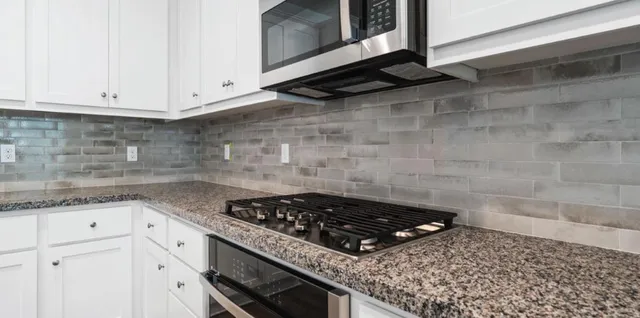 a stove top oven sitting inside of a kitchen