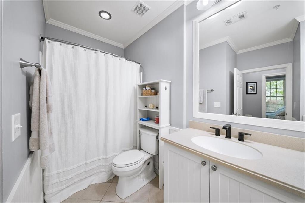 4100 Paces Walk Southeast, Unit 1101 Atlanta, GA 30339 - Photo 25 of 36 a bathroom with a sink a toilet and shower