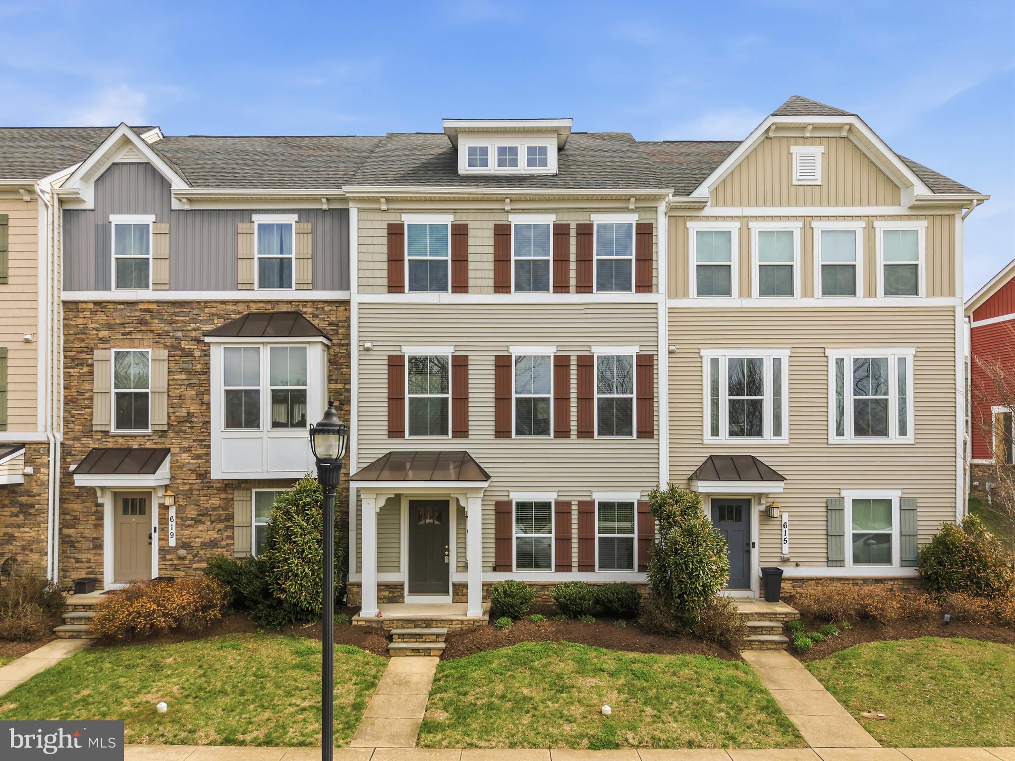 617 Potomac View Parkway Brunswick, MD 21716 - Photo 26 of 48 a front view of a residential apartment building with a yard