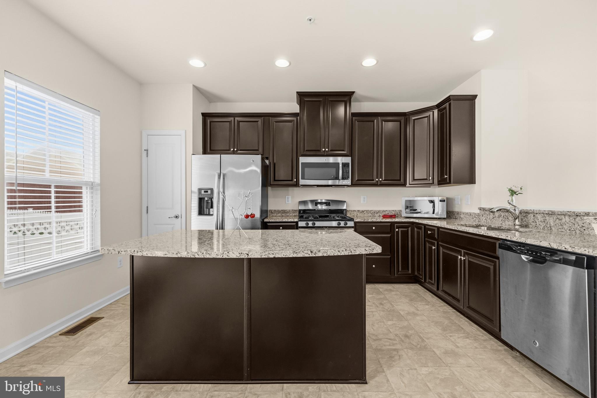 617 Potomac View Parkway Brunswick, MD 21716 - Photo 5 of 48 a kitchen with kitchen island granite countertop a sink stove and refrigerator