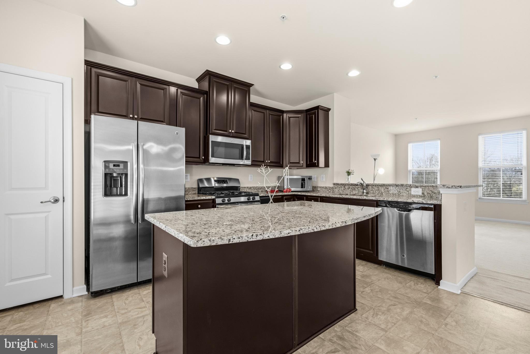 617 Potomac View Parkway Brunswick, MD 21716 - Photo 6 of 48 a kitchen with stainless steel appliances granite countertop a refrigerator a sink and a stove