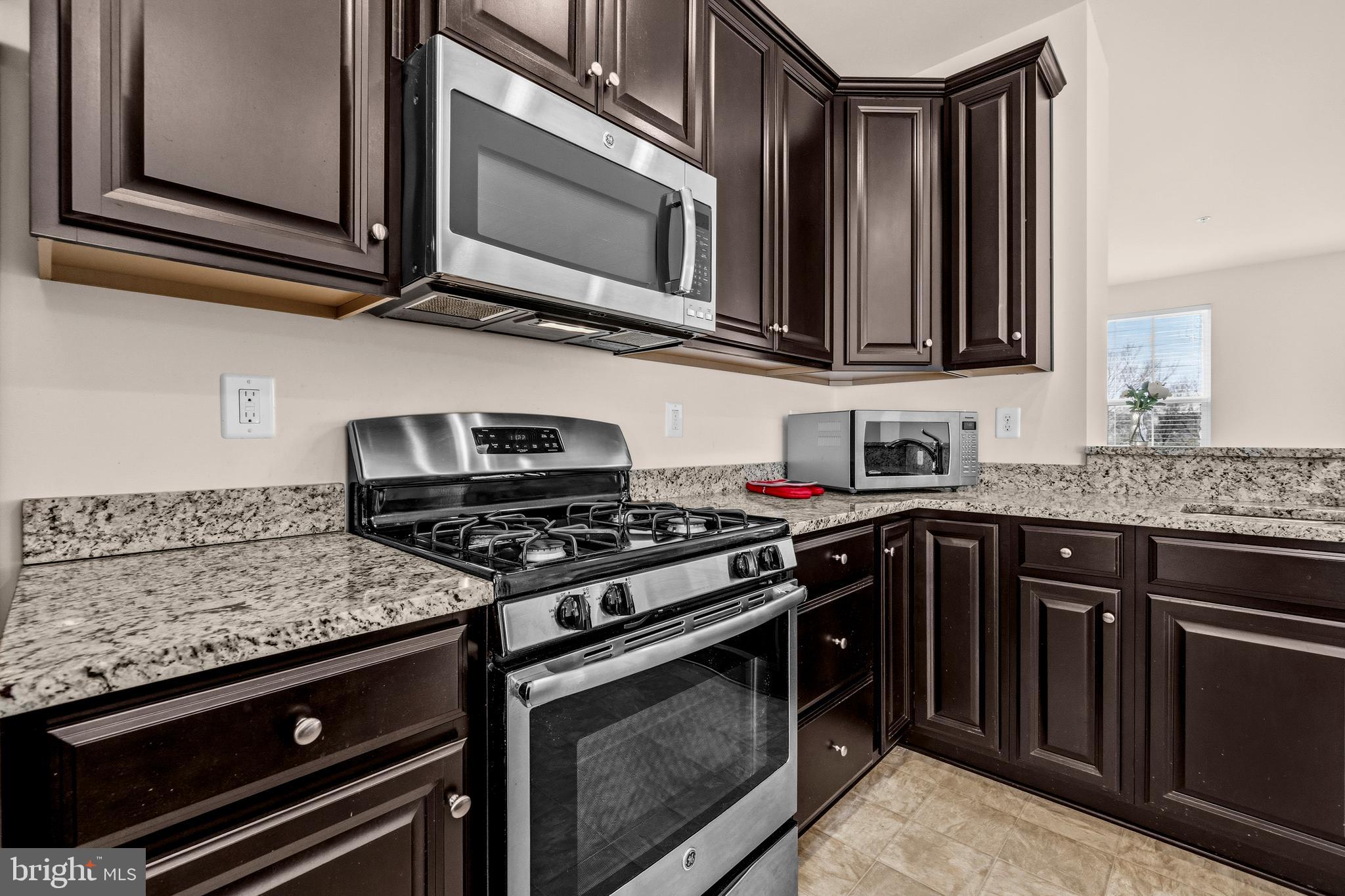 617 Potomac View Parkway Brunswick, MD 21716 - Photo 8 of 48 a kitchen with stainless steel appliances granite countertop a stove and a microwave