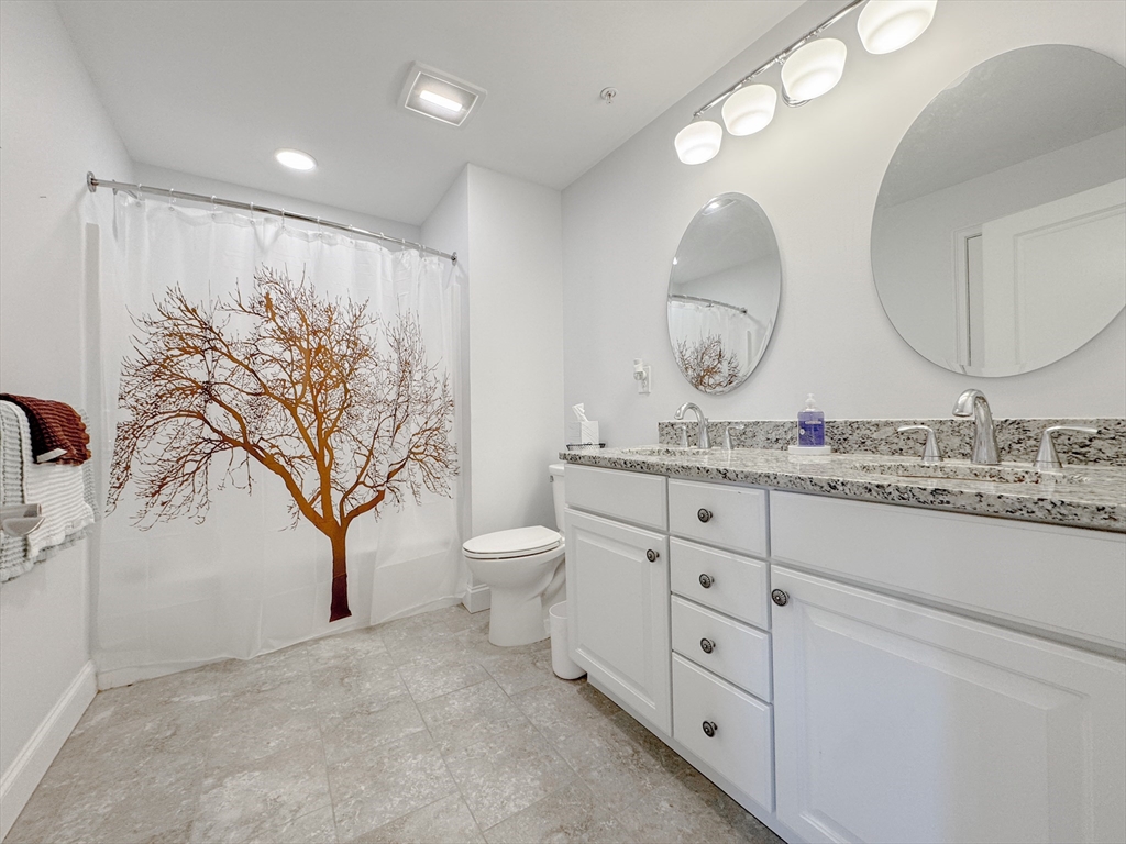18 Eagle Nest Road, Unit 331 Clinton, MA 01510 - Photo 12 of 28 a bathroom with a granite countertop toilet sink and mirror