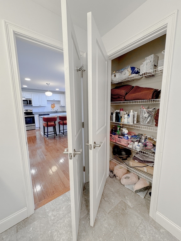 18 Eagle Nest Road, Unit 331 Clinton, MA 01510 - Photo 13 of 28 a view of a hallway with dining area and chandelier