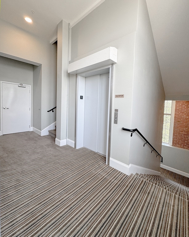 18 Eagle Nest Road, Unit 331 Clinton, MA 01510 - Photo 17 of 28 a view of an empty room with wooden floor and a window