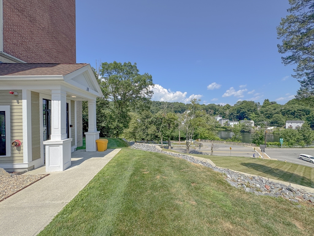 18 Eagle Nest Road, Unit 331 Clinton, MA 01510 - Photo 26 of 28 a view of a house with a yard and sitting area