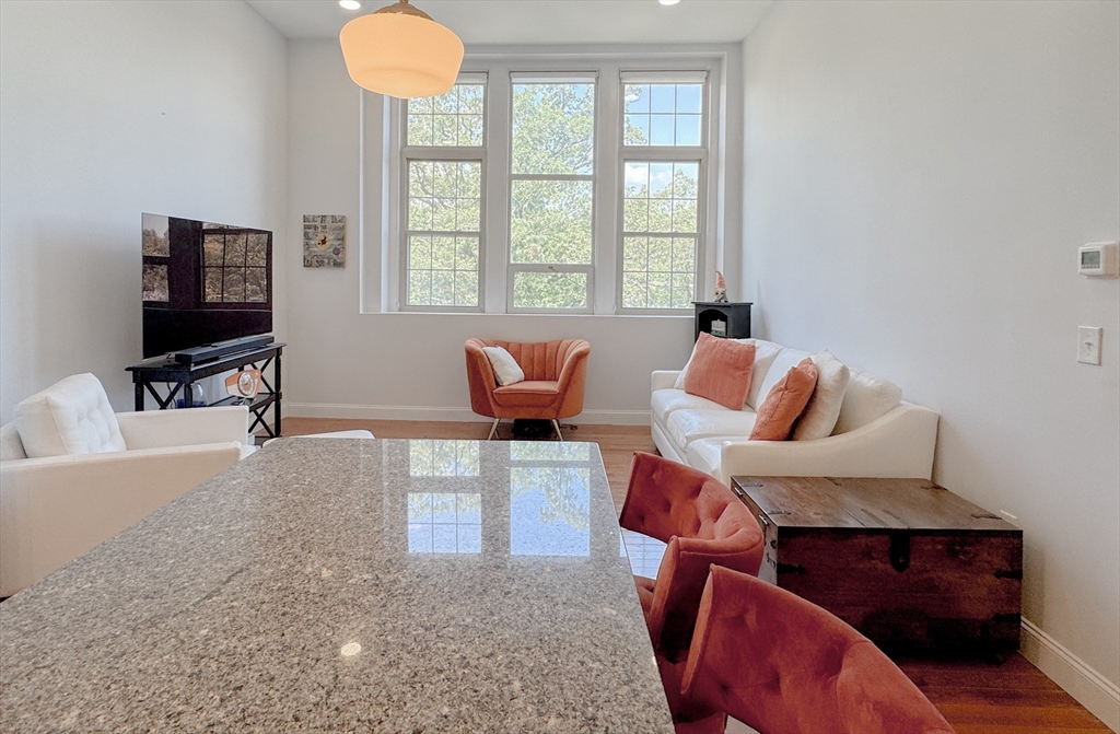 18 Eagle Nest Road, Unit 331 Clinton, MA 01510 - Photo 3 of 28 a living room with furniture a flat screen tv and a window
