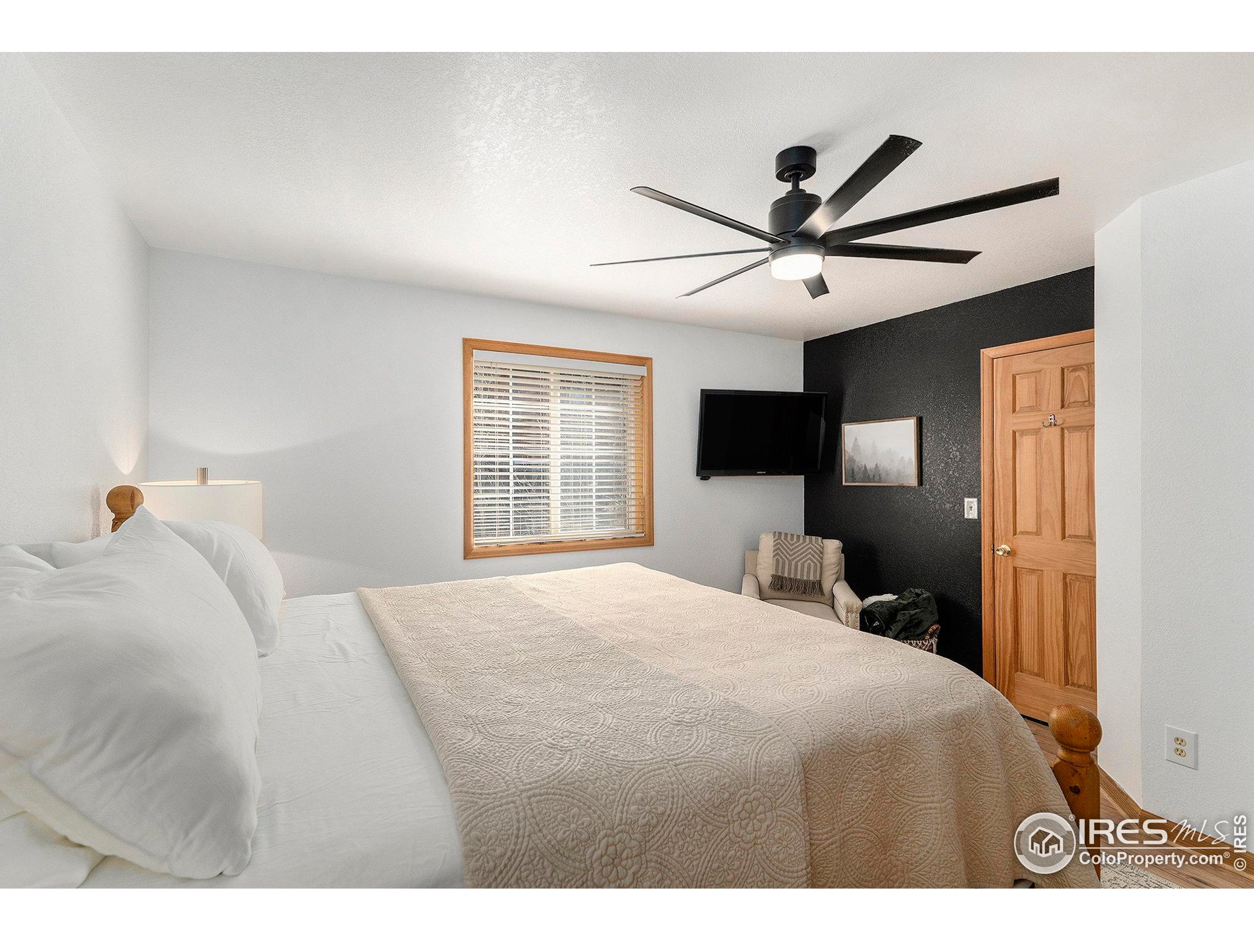 654 Piaute Way Como, CO 80432 - Photo 14 of 25 a bedroom with a bed and a tv