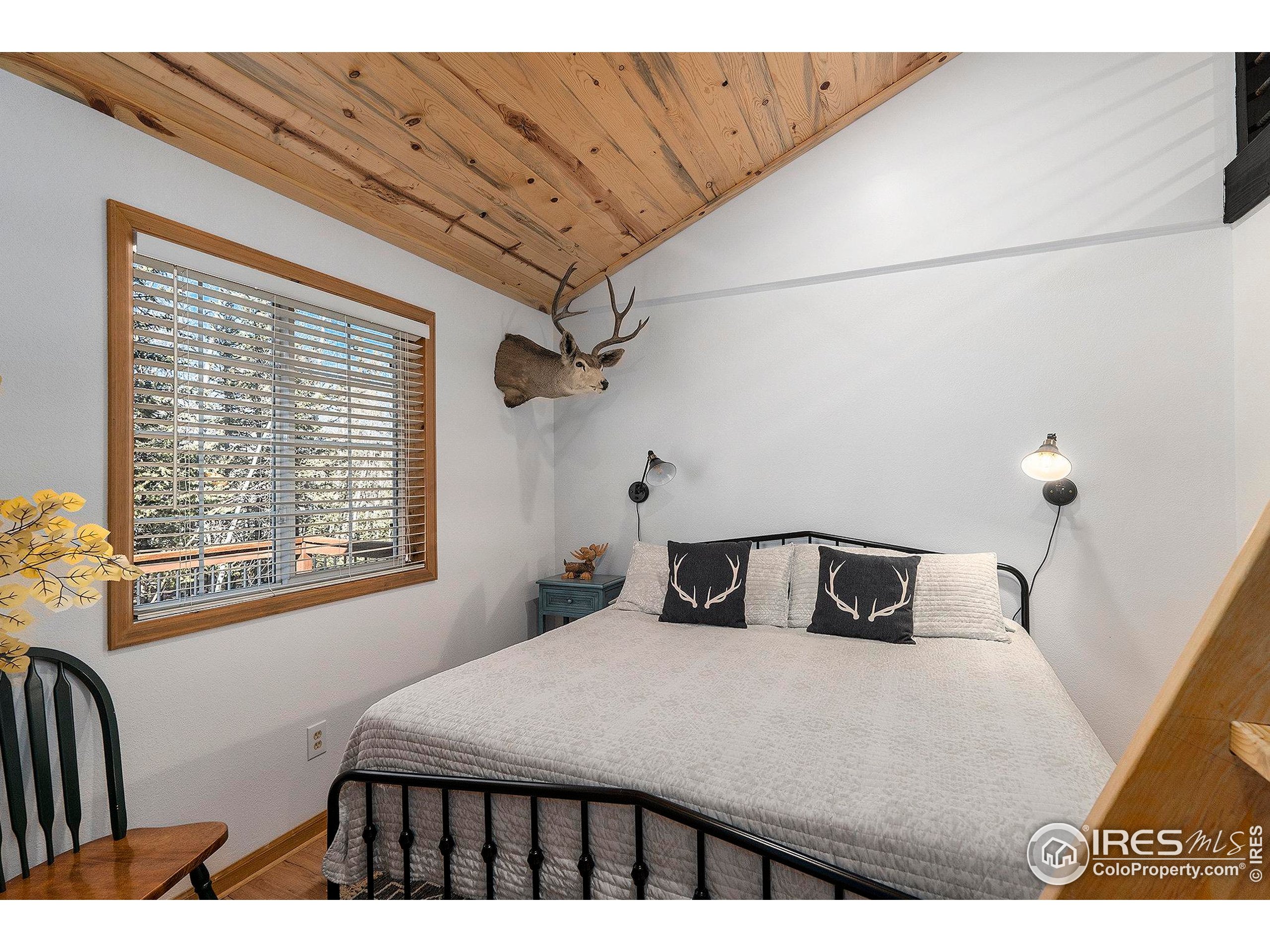 654 Piaute Way Como, CO 80432 - Photo 15 of 25 a bedroom with a bed and a window