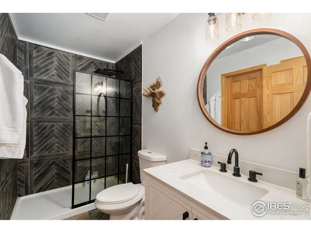 a bathroom with a sink toilet and mirror