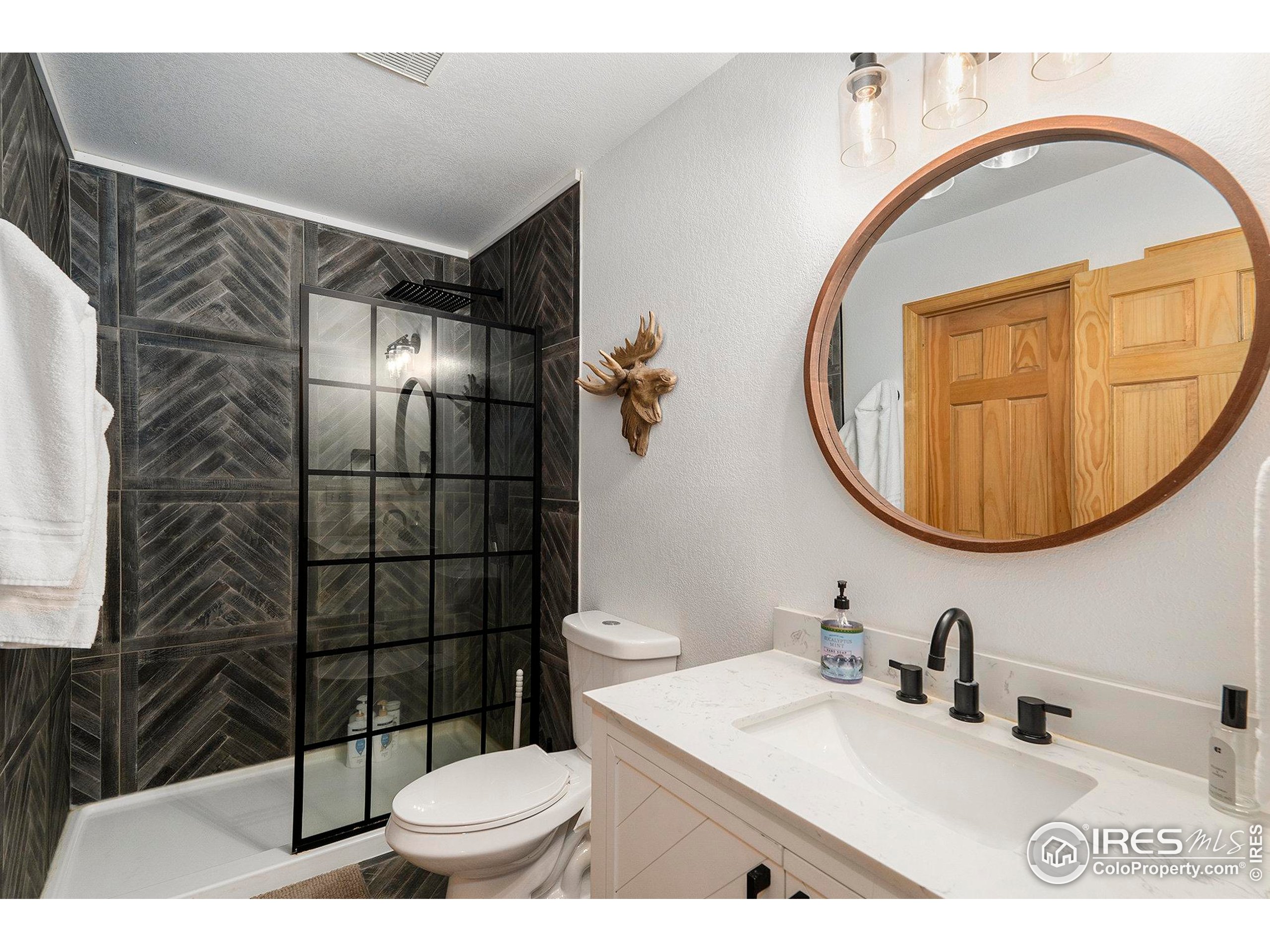 654 Piaute Way Como, CO 80432 - Photo 18 of 25 a bathroom with a sink toilet and mirror