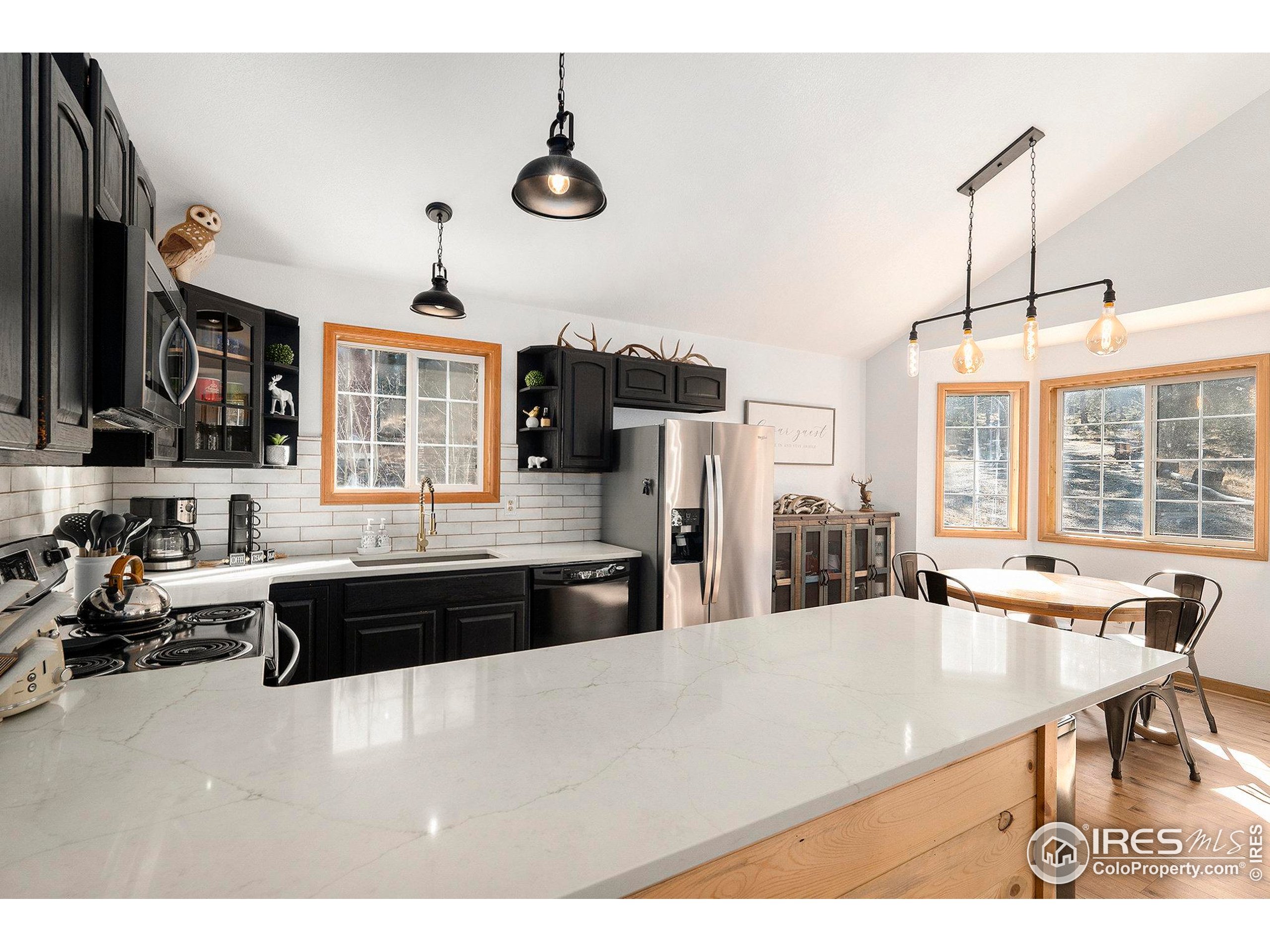 654 Piaute Way Como, CO 80432 - Photo 10 of 25 a large kitchen with stainless steel appliances granite countertop a stove and cabinets