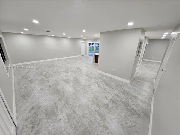an empty room with wooden floor and a window