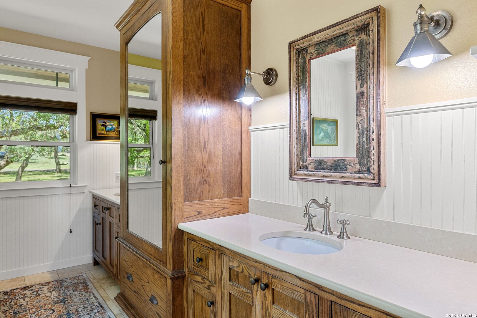 7855 Middle Creek Road Blanco, TX 78606 - Photo 19 of 57 a bathroom with a granite countertop sink and a mirror