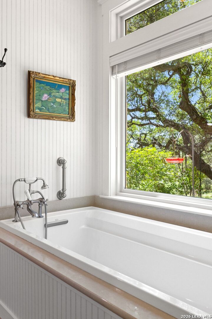 7855 Middle Creek Road Blanco, TX 78606 - Photo 21 of 57 a bathroom with a granite countertop sink and a large mirror