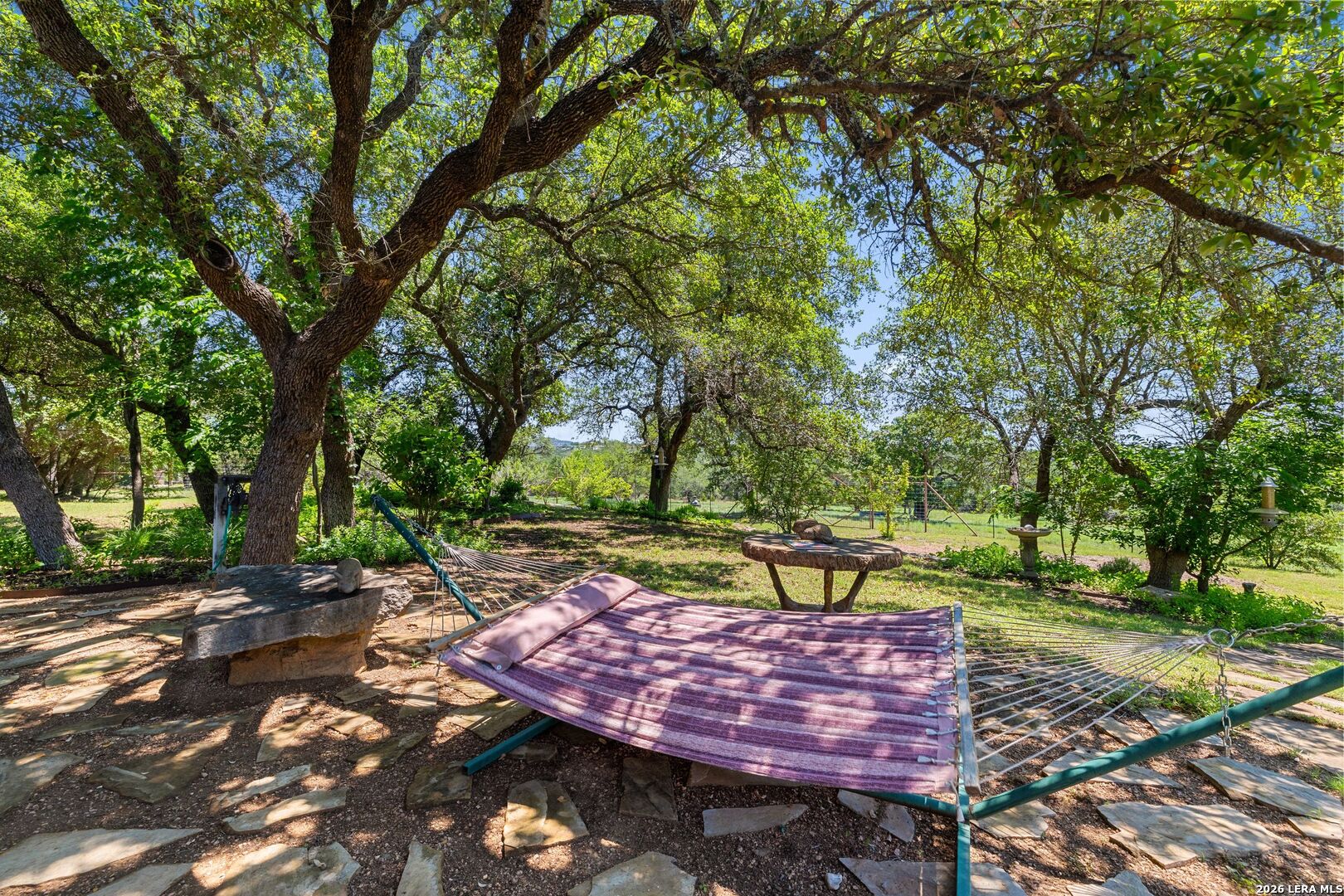 7855 Middle Creek Road Blanco, TX 78606 - Photo 36 of 57 a view of a backyard with a table and chairs