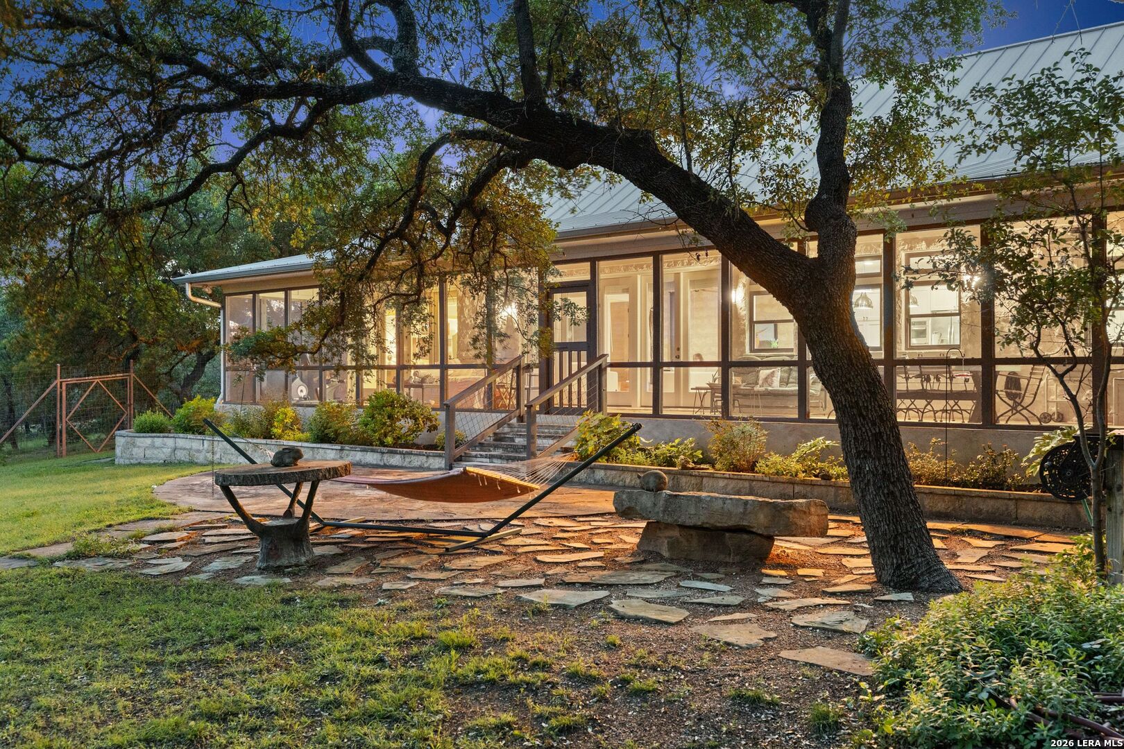 7855 Middle Creek Road Blanco, TX 78606 - Photo 38 of 57 a view of a swimming pool with a bench and trees in the background