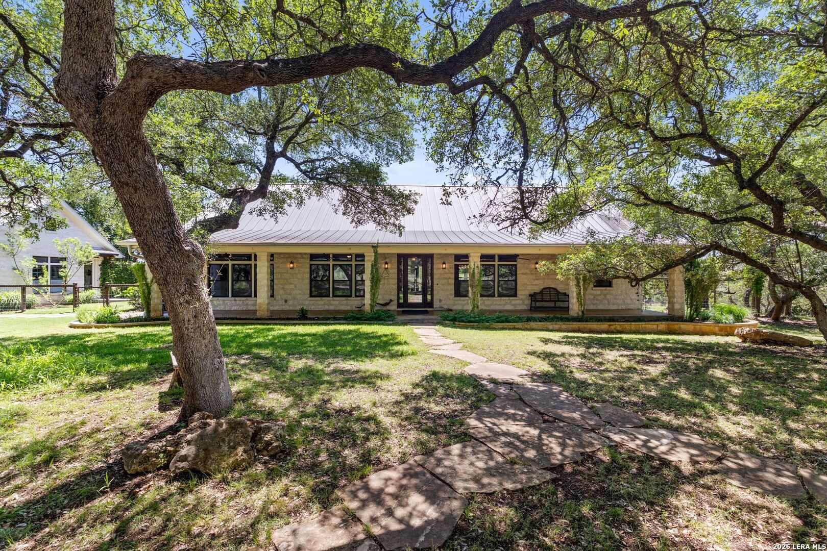 7855 Middle Creek Road Blanco, TX 78606 - Photo 6 of 57 a front view of a house with a garden
