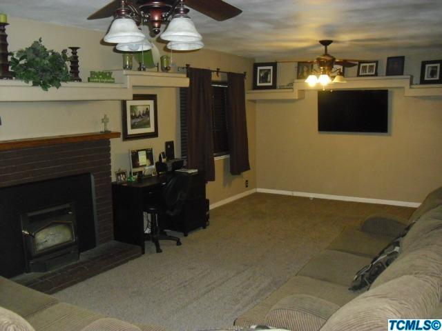 Living room with masonry fireplace with