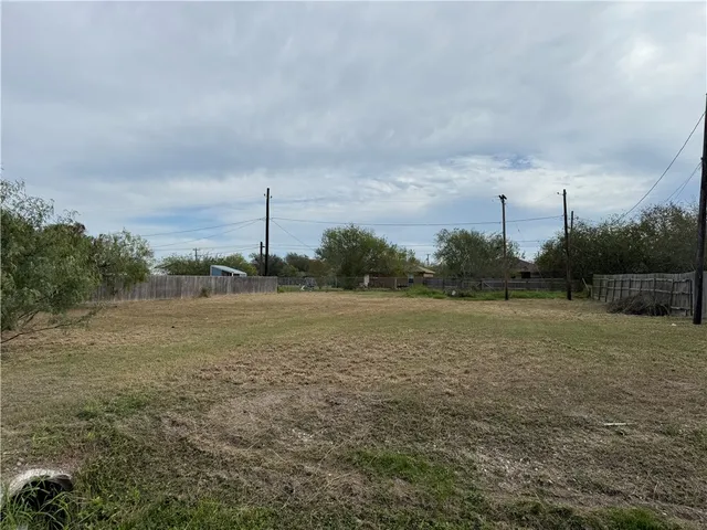 a view of a field with wooden fence
