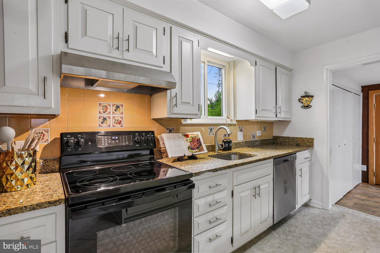 907 Hoyt Street Silver Spring, MD 20902 - Photo 22 of 69 a kitchen with stainless steel appliances granite countertop a sink stove and cabinets