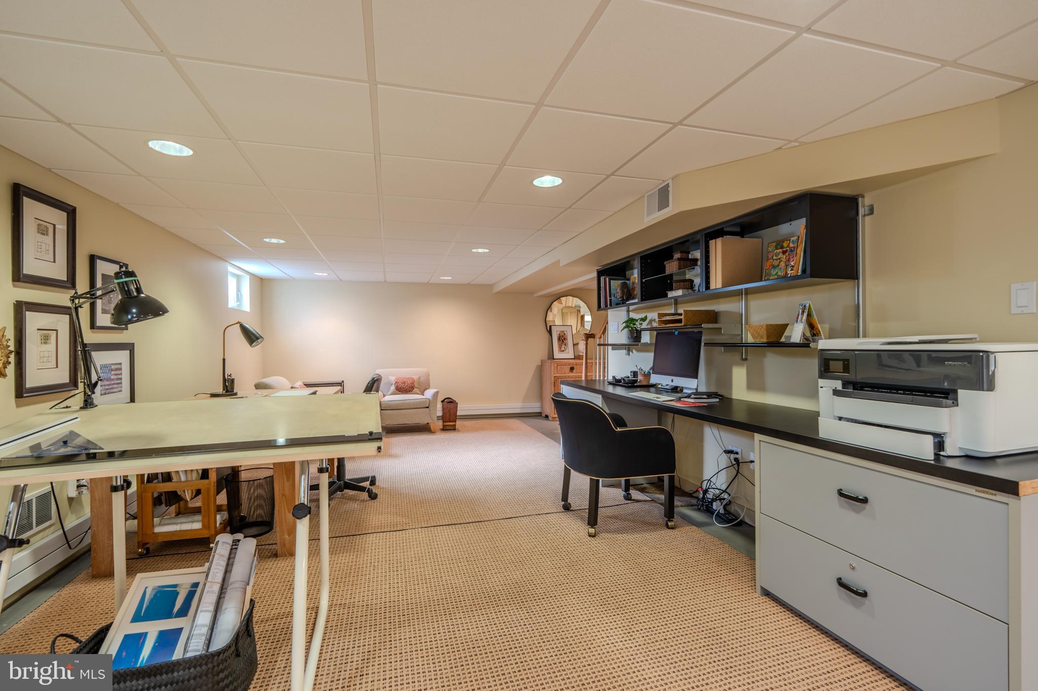 173 Hillview Drive Springfield, PA 19064 - Photo 31 of 50 a room with stainless steel appliances kitchen island granite countertop a table chairs and a refrigerator