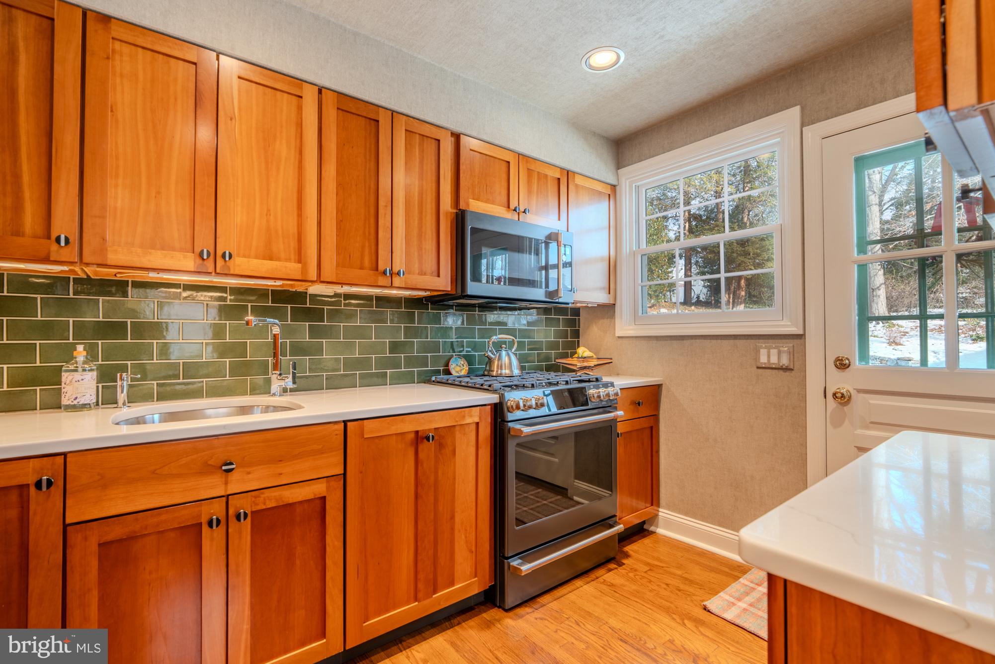 173 Hillview Drive Springfield, PA 19064 - Photo 9 of 50 a kitchen with stainless steel appliances granite countertop wooden cabinets a sink and a stove