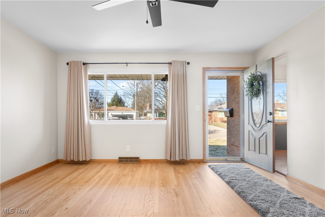 615 Ingalls Road Akron, OH 44312 - Photo 6 of 50 Foyer with visible vents, baseboards, ceiling fan, and wood finished floors