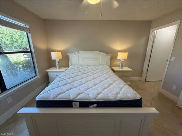 a bedroom with a bed and window