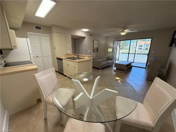a view of a dining room with furniture wooden floor and a chandelier