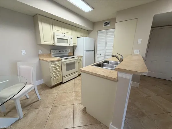 a kitchen with a sink stove and refrigerator