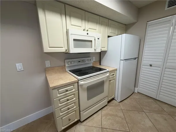 a kitchen with a stove microwave and refrigerator