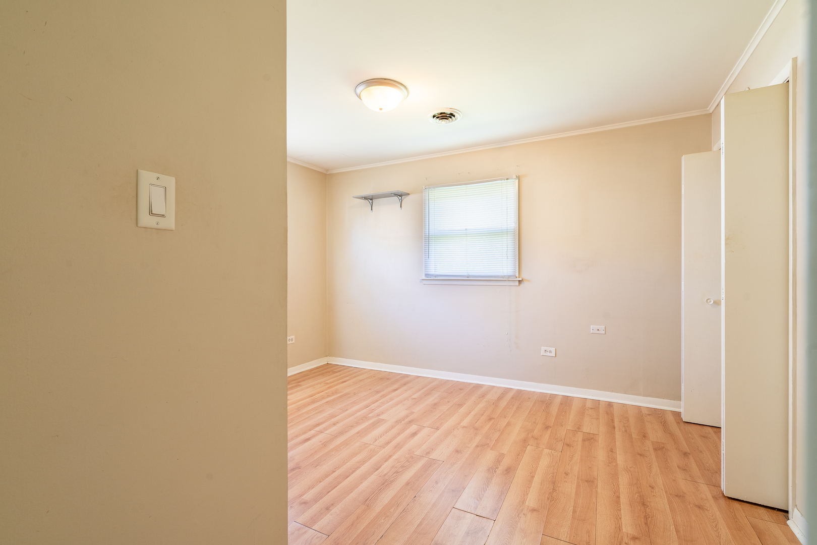 357 Neola Street Park Forest, IL 60466 - Photo 13 of 22 a view of an empty room with wooden floor and a window