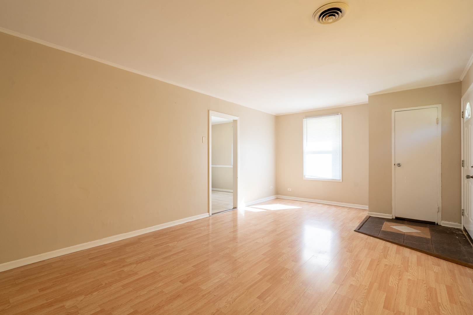 357 Neola Street Park Forest, IL 60466 - Photo 4 of 22 an empty room with wooden floor and windows