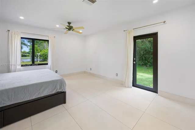 a spacious bedroom with a bed and a window