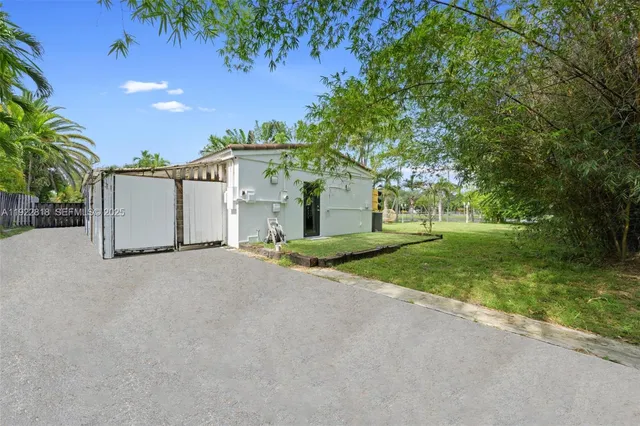 a view of a house with a yard and garage