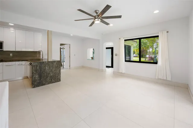 a view of a kitchen with a sink and a window