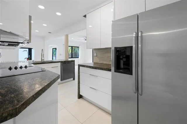 a large kitchen with cabinets and stainless steel appliances