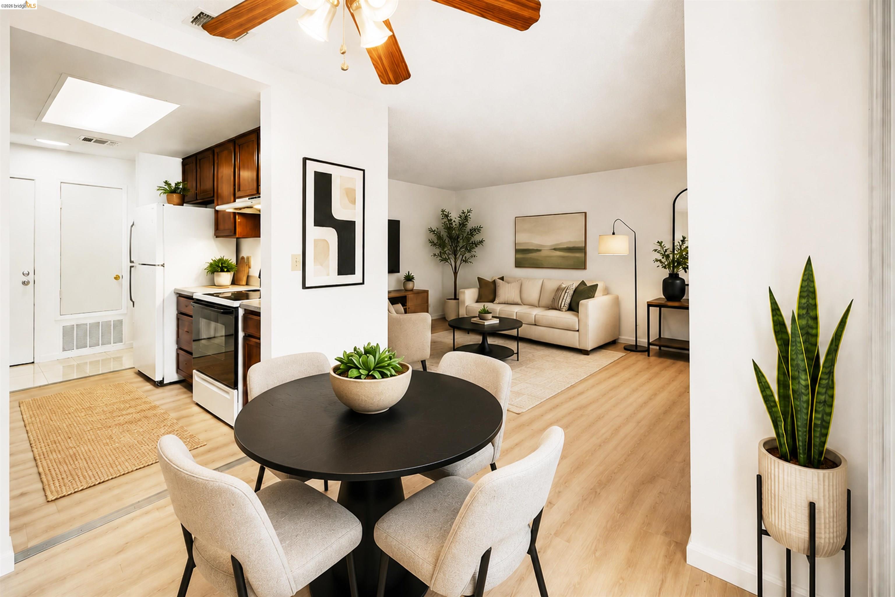 4186 San Pablo Dam Road, Unit A El Sobrante, CA 94803 - Photo 23 of 34 Combined living and dining space featuring wood-finish flooring, a ceiling fan with integrated lighting, and white painted walls