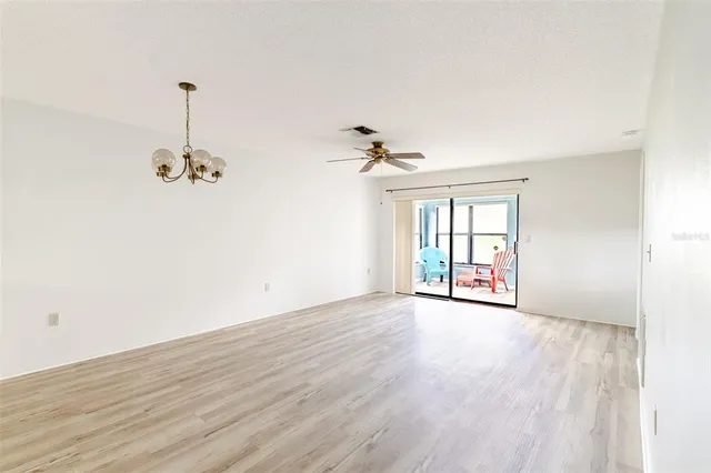a living room with furniture and floor to ceiling windows