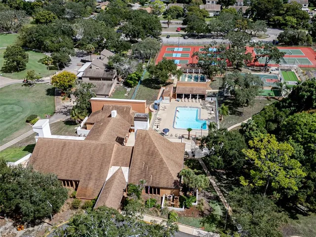 an aerial view of house with swimming pool and outdoor seating