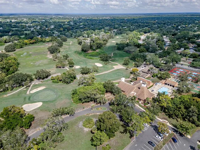 an aerial view of residential house with outdoor space and trees around