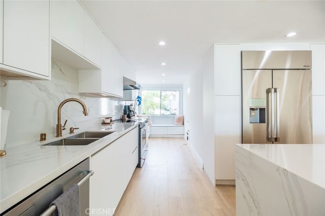 a kitchen with a sink and a refrigerator