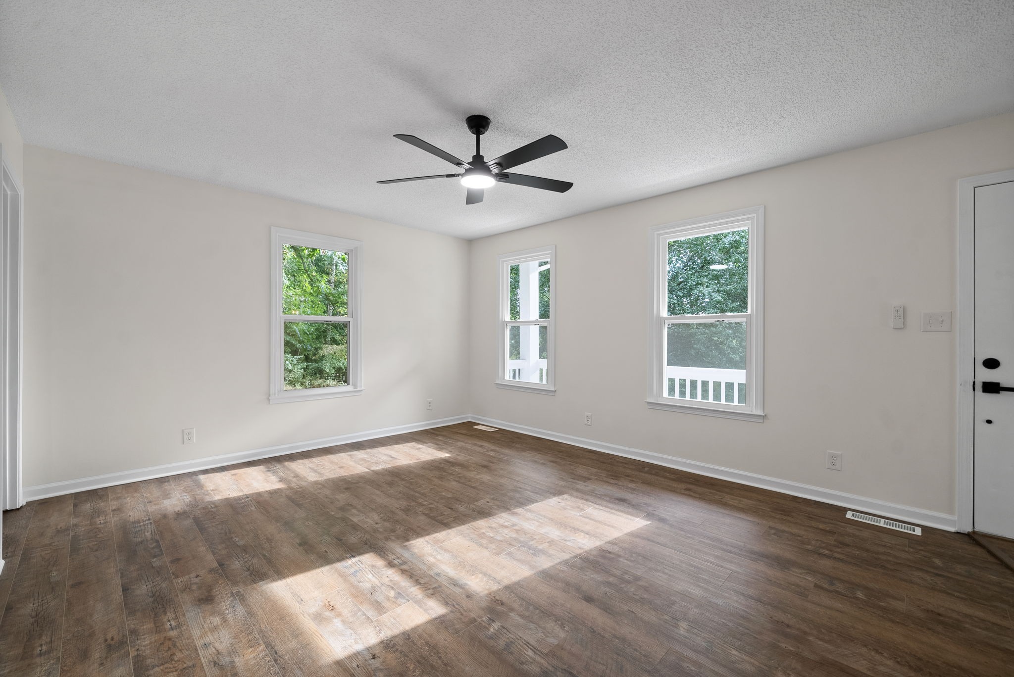 2212 Bend Road Clarksville, TN 37040 - Photo 4 of 32 a view of an empty room with a window and wooden floor