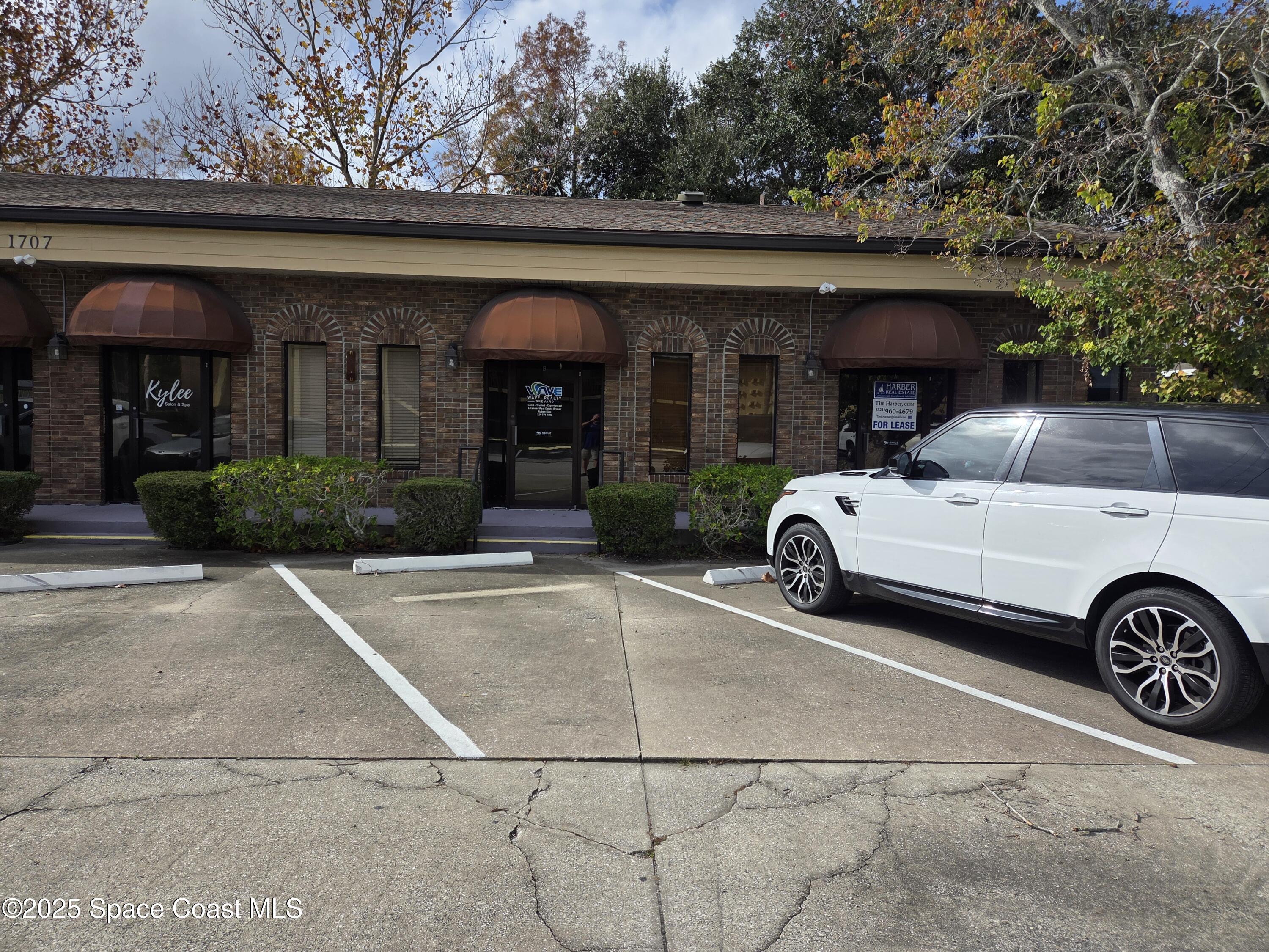 1707 Elm Street, Unit F Rockledge, FL 32955 - Photo 2 of 5 a view of a car parked in front of a building