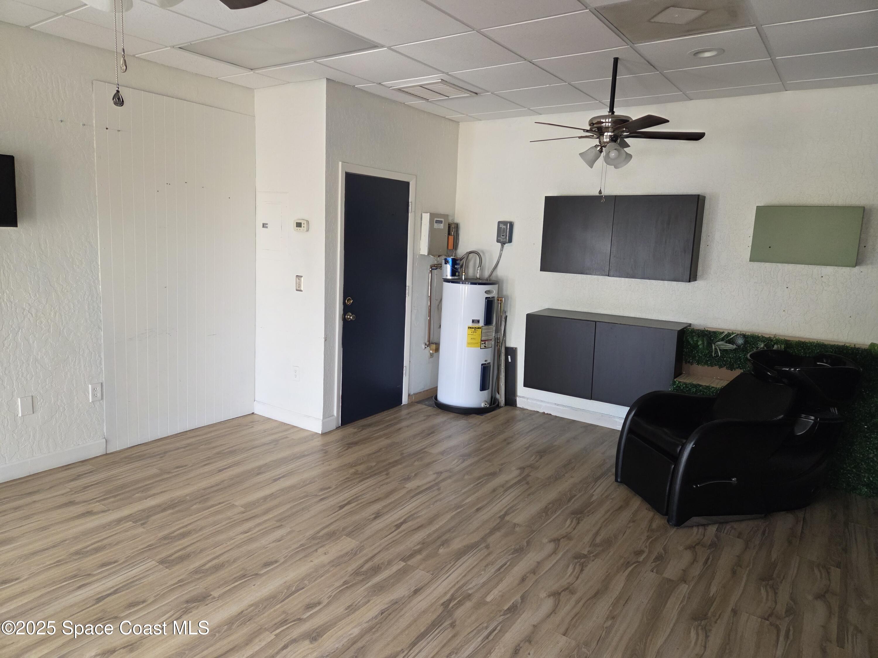 1707 Elm Street, Unit F Rockledge, FL 32955 - Photo 3 of 5 a living room with furniture and a flat screen tv
